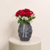 Luxury arrangement of premium red roses with white filler flowers in an elegant black vase by Marino Flowers.