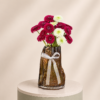 Elegant arrangement of red and white gerbera daisies in a luxury decorative vase by Marino Flowers.