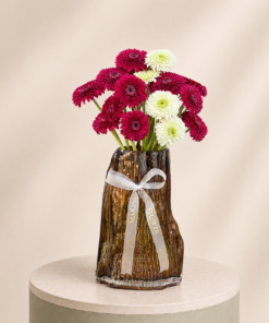 Elegant arrangement of red and white gerbera daisies in a luxury decorative vase by Marino Flowers.