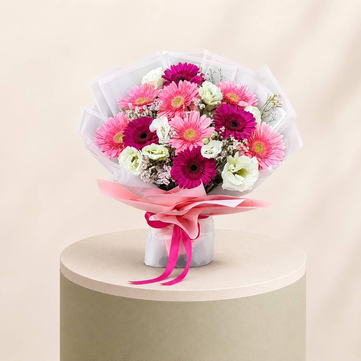 Pink gerbera and lisianthus bouquet with baby’s breath wrapped in pink and white paper by Marino Flowers.