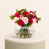 Luxury arrangement of red and blush pink roses in an elegant glass bowl vase by Marino Flowers.
