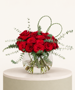 Luxury red rose arrangement with eucalyptus and heart-shaped greenery in a glass bowl vase by Marino Flowers.