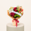 Medium bouquet with red tulips, red roses, white seasonal flowers, green chrysanthemums, kraft wrapping, and red ribbon by Marino Flowers.