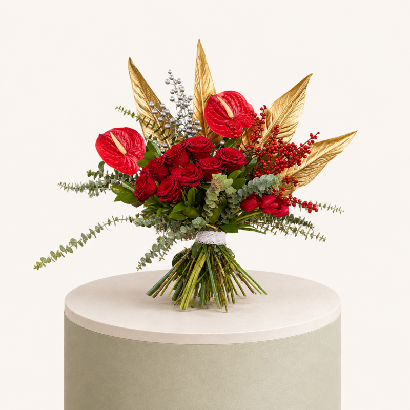 Luxury bouquet with red roses, red anthuriums, red tulips, eucalyptus, berries, and gold palm leaves by Marino Flowers.