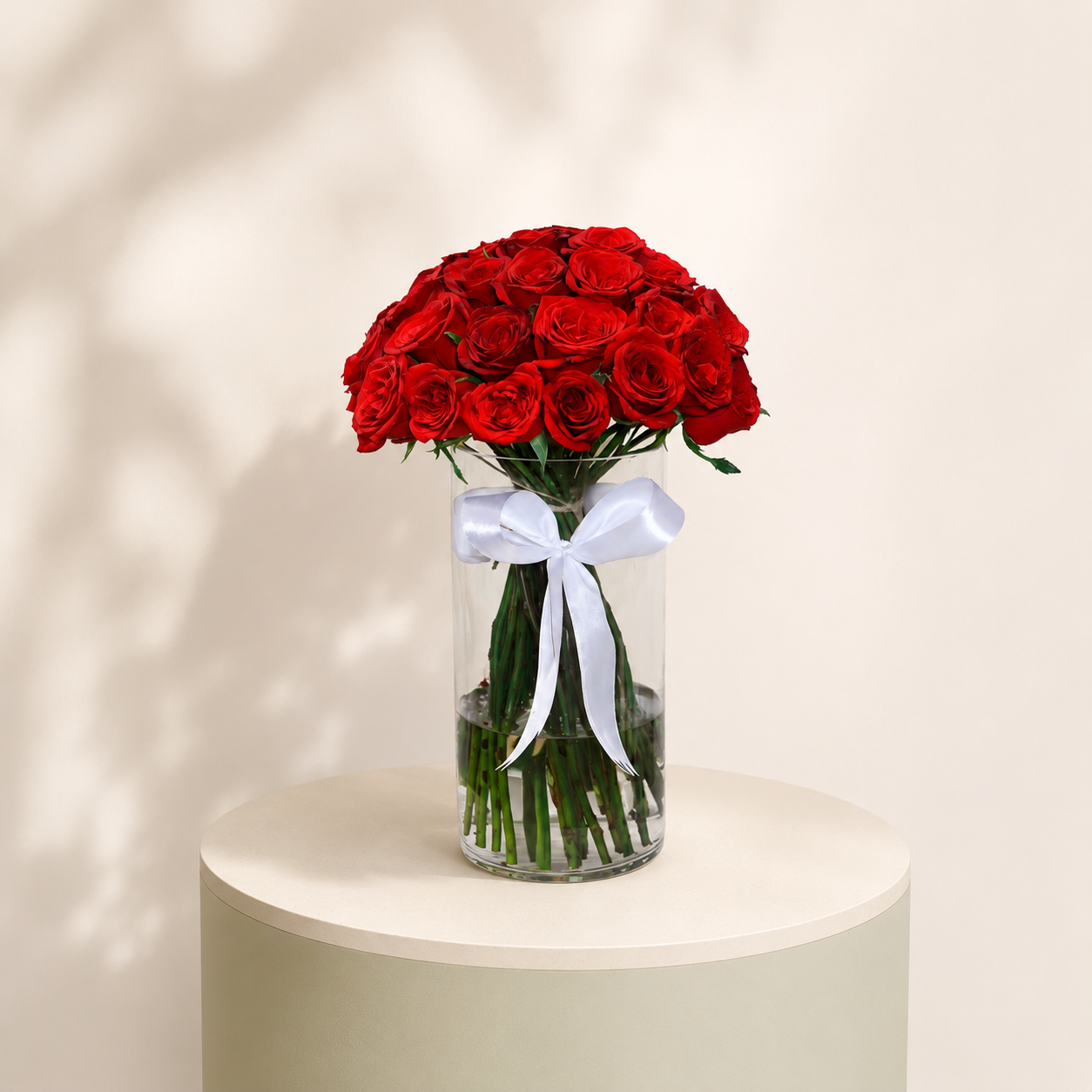 40 premium red roses arranged in a luxury glass vase with a white ribbon by Marino Flowers.