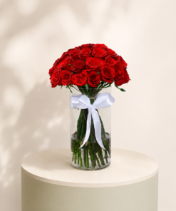 40 premium red roses arranged in a luxury glass vase with a white ribbon by Marino Flowers.