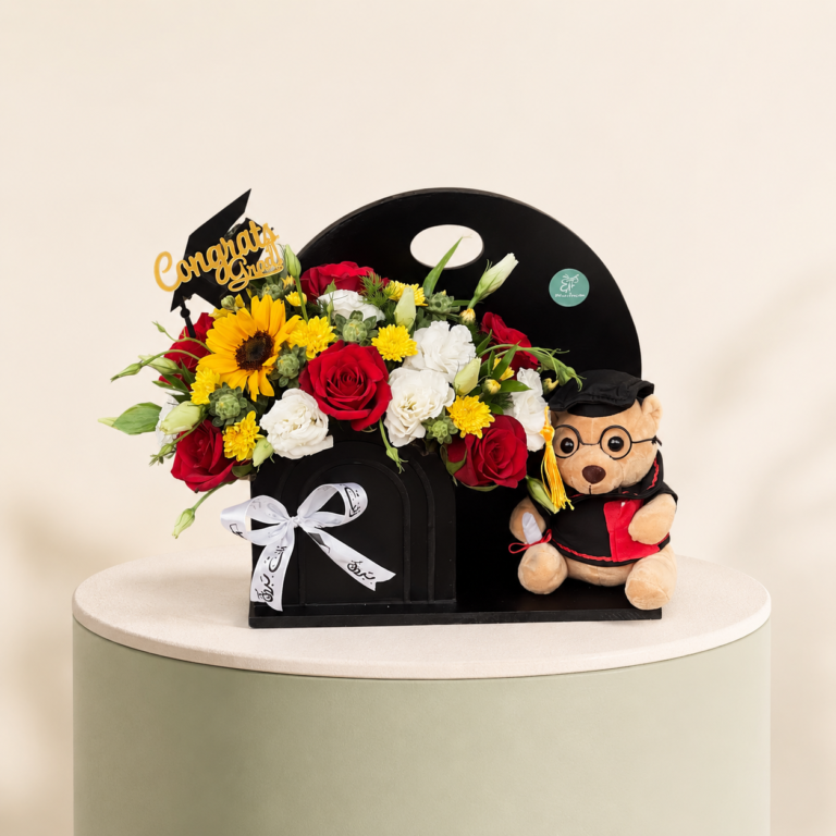 Graduation black stand with red roses, sunflowers, lisianthus, and teddy bear by Marino Flowers