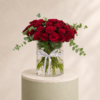 Luxury red roses with eucalyptus arranged in a clear glass vase by Marino Flowers