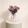 Pink spray roses arranged in a clear glass vase with a pink satin ribbon by Marino Flowers