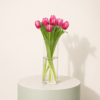 Fresh pink tulips arranged in a clear glass vase by Marino Flowers.